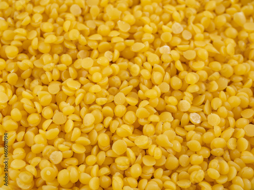 background of yellow pearls of natural beeswax