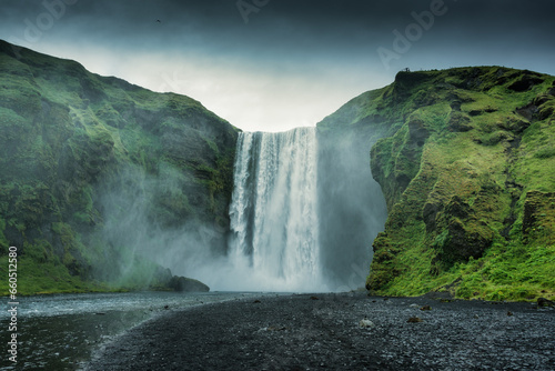 Powerful Skogafoss waterfall in summer on gloomy day at Iceland