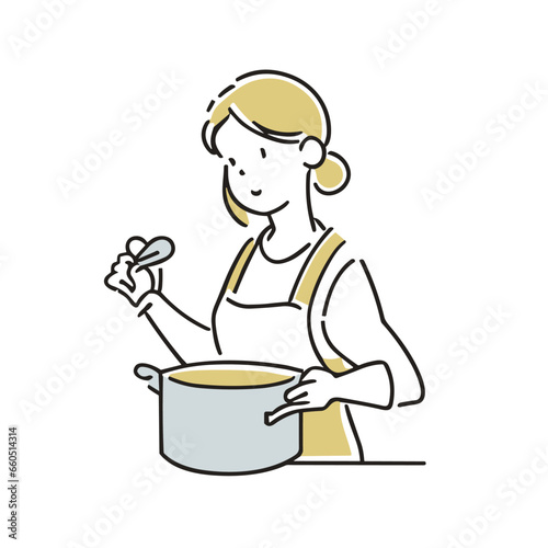 エプロンを着て料理をする女性