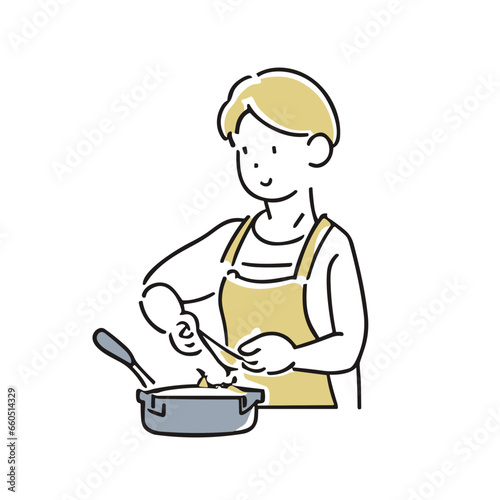エプロンを着て料理をする男性