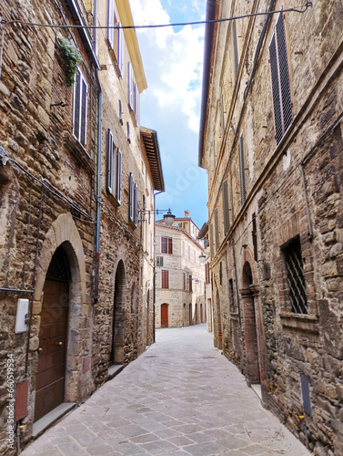 Fototapeta Naklejka Na Ścianę i Meble -  Discover a charming Umbrian village street with rustic stone houses. Capture timeless Italian charm.