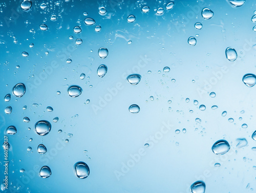 Extreme close-up of water droplets with ample space for text in a blue background.