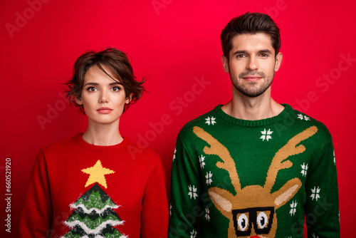Photo of attractive pretty married couple wear ornament sweaters isolated red color background