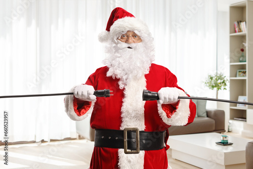 Santa Claus unplugging cables in an apartment