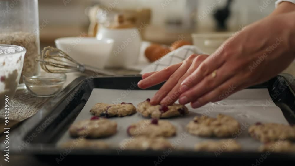 Delicious. A young girl in home clothes confidently preparing dough for baking cookies in the kitchen. General view of a junk food watcher placing dough on a baking tray using kitchen utensils to bake Delicious. A young girl in home clothes confidently preparing dough for baking cookies in the kitchen. General view of a junk food watcher placing dough on a baking tray using kitchen utensils to bake