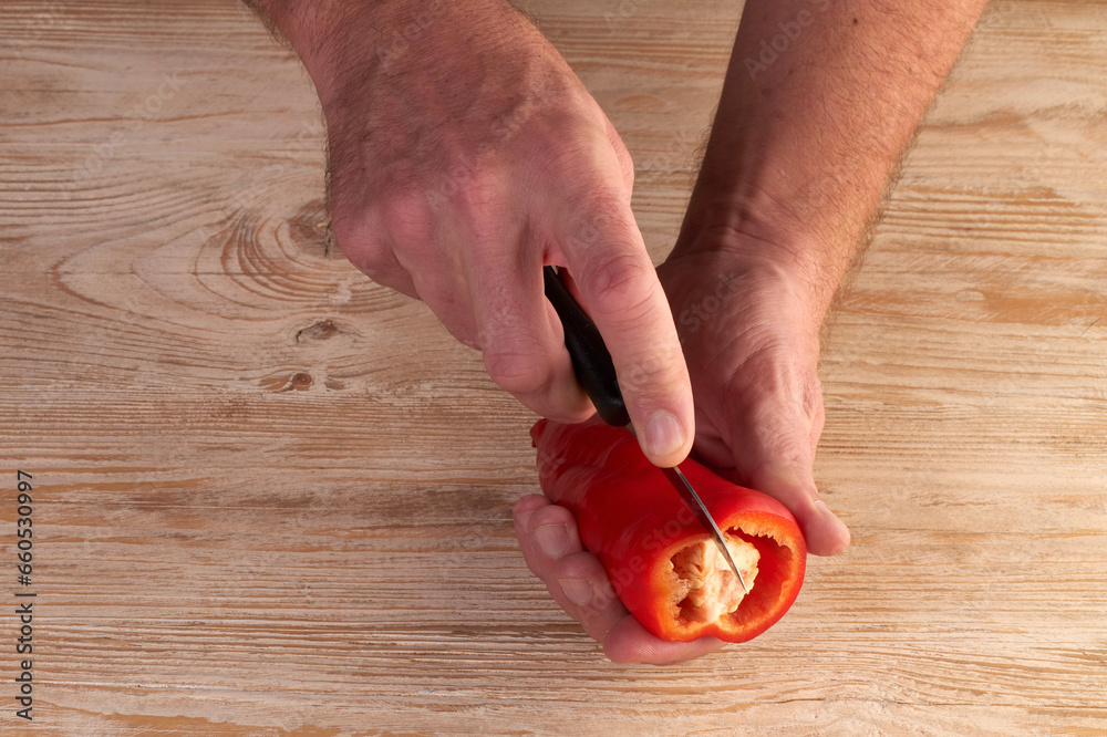 Men's hands are catting fresh pepper Men's hands are catting fresh pepper