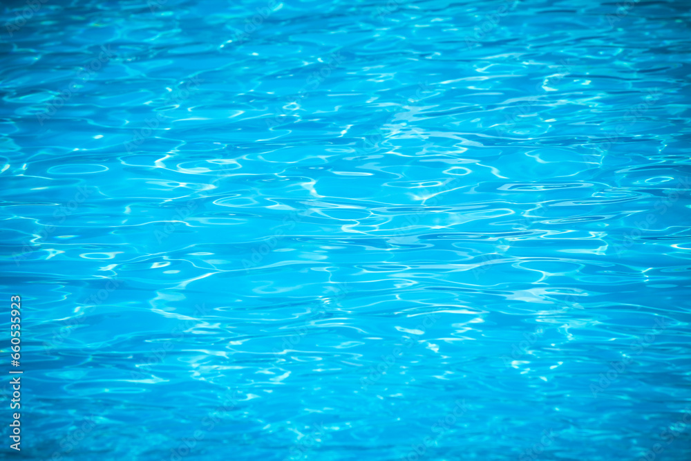 Water and air bubbles over blue background,sea wave ,Bokeh light background in the pool,Hotel swimming pool with sunny reflections. Water and air bubbles over blue background,sea wave ,Bokeh light background in the pool,Hotel swimming pool with sunny reflections.