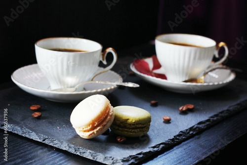 Close-up of coffee with macaroons on table