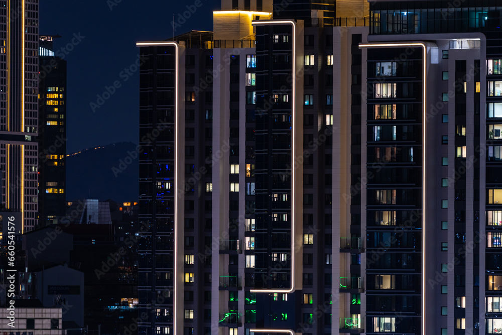 Night view of the city showing modern apartments colorfully decorated with neon-like lighting