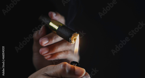 A man smoking cigar in dark room