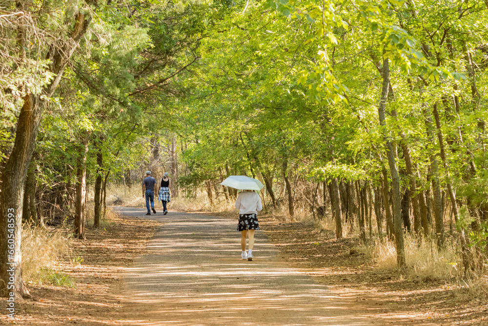 People walking in the Bluff Creek Park People walking in the Bluff Creek Park