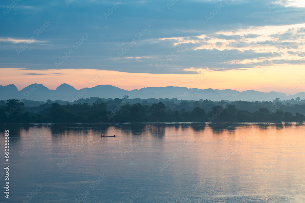 beautiful scenery The sun rises over the mountains in the early morning. In the foreground is the Mekong River, the border point for Thailand and Laos.