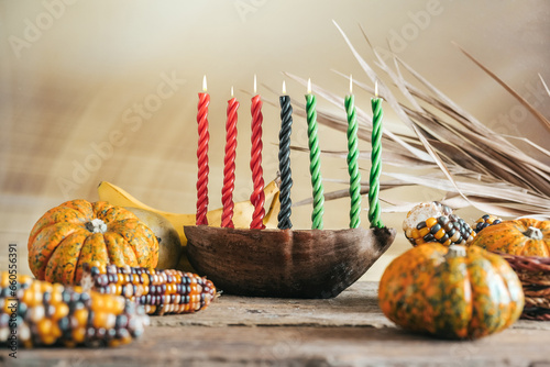 Kwanzaa, african holiday Kwanzaa with decoration of seven candles in red, black and green colors, vegetable harvest, corn. Greeting card banner. Happy Kwanzaa photo