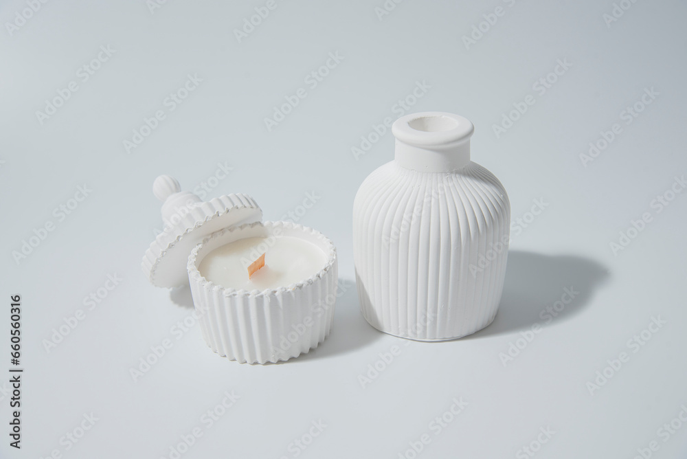 candle in white ceramic pot on a white background ,a vase with a candle.Cozy home natural eco decor candle in white ceramic pot on a white background ,a vase with a candle.Cozy home natural eco decor