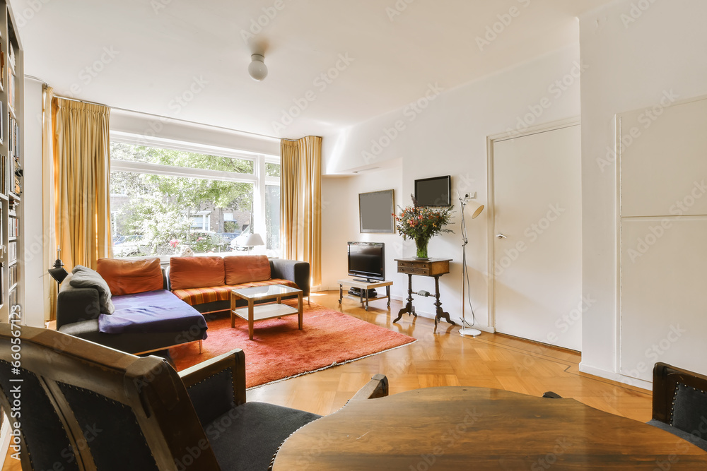 a living room with couches, chairs and a flat screen tv on the wall in the corner of the room a living room with couches, chairs and a flat screen tv on the wall in the corner of the room