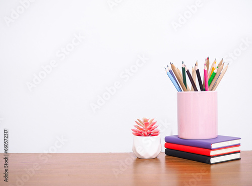 Office desk table, Student creative desktop with colorful stationery, hardcover book, potted cactus. Copy space for text, Back to school, Education concept