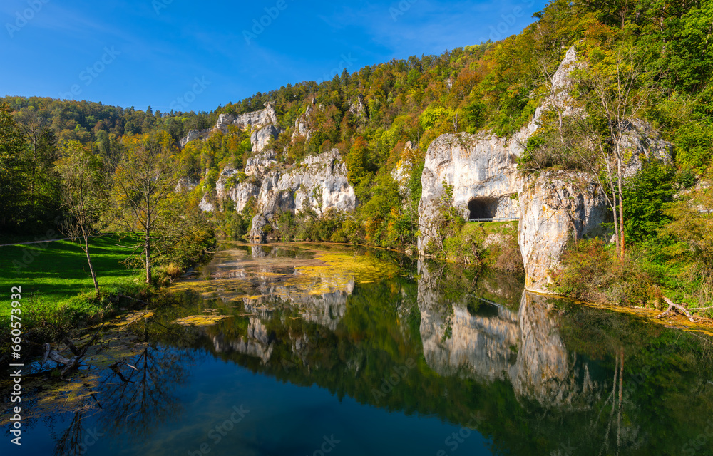 Panoramic view of Danube river valley near Sigmaringen, Germany. Limestone cliffs, colorful foliage and clear water reflecting idyllic scenery. Road between Dietfurt and Gutenstein with tunnels.