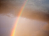 The Rainbow In A Cloudy Sunset Sky