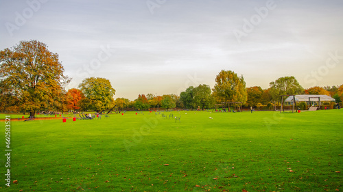Mannheim, Germany. Playground for children and families. Panoramic view over Luisen city park at sunset golden Autumn colors. Cityscape in the historical downtown at sunny day and milky blue sky. © neurobite
