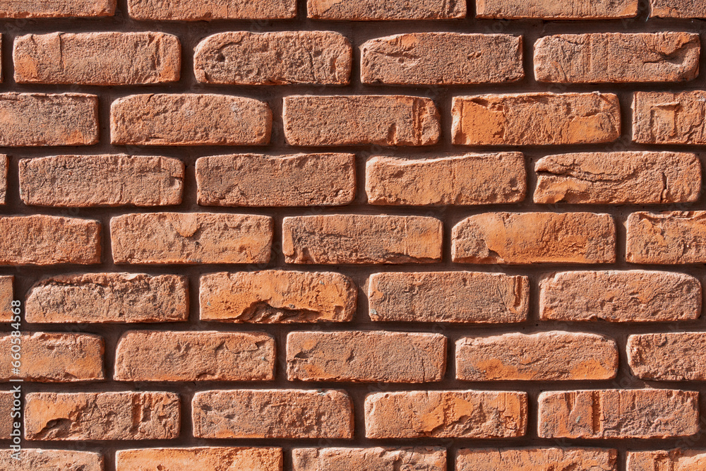 Obraz premium Brown, red brick wall background with seams. Space for text. Texture close-up.