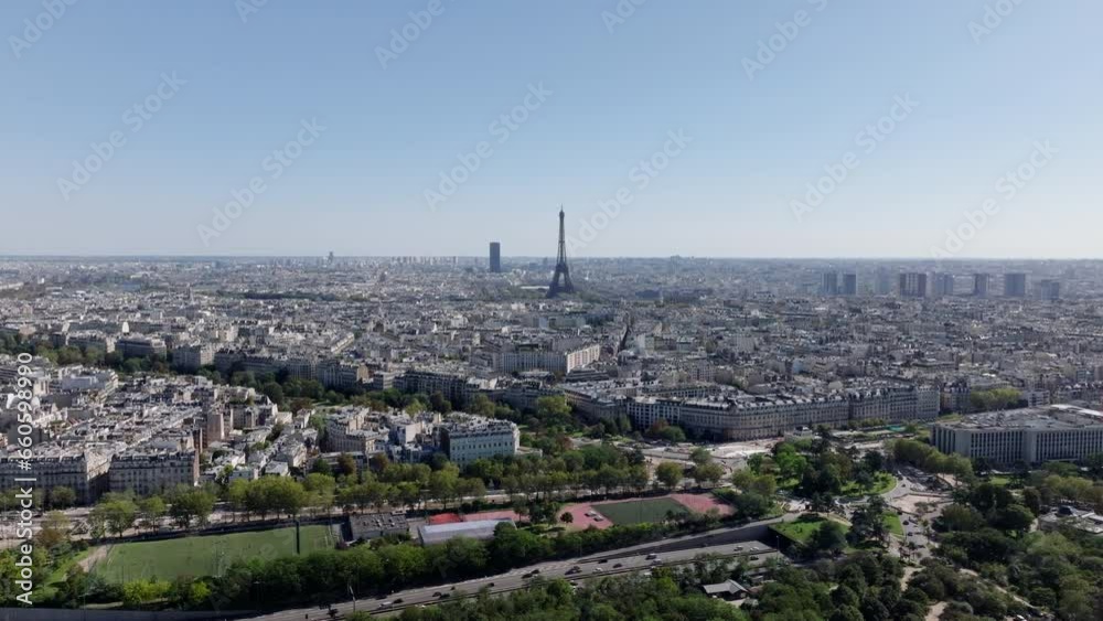 Aerial panoramic view of metropolis in flat landscape. Buildings in urban boroughs and famous sights. Eiffel Tower above town development. Paris, France Aerial panoramic view of metropolis in flat landscape. Buildings in urban boroughs and famous sights. Eiffel Tower above town development. Paris, France