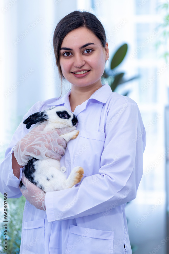 Scientist or pharmacist holding cute fluffy Bunny in laboratory. Friendship with Easter Bunny. Scientist or pharmacist holding cute fluffy Bunny in laboratory. Friendship with Easter Bunny.