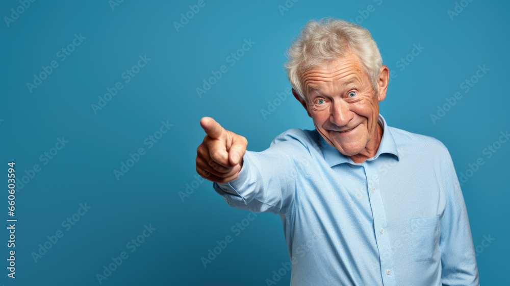 Senior man pointing with hand and finger to the side looking at the camera. Senior man pointing with hand and finger to the side looking at the camera.