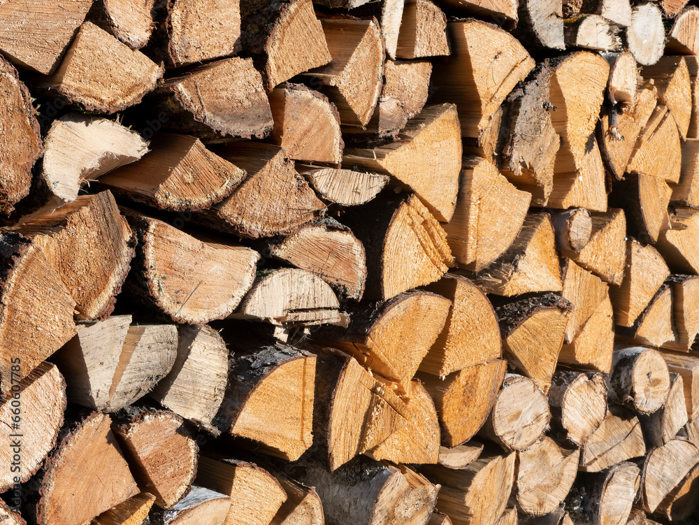 Woodpile lies in a heap, chopped for burning in a furnace. Finely chopped and stacked firewood, background. Laid dry firewood, texture, background. Firewood wall, dry chopped firewood background. Woodpile lies in a heap, chopped for burning in a furnace. Finely chopped and stacked firewood, background. Laid dry firewood, texture, background. Firewood wall, dry chopped firewood background.