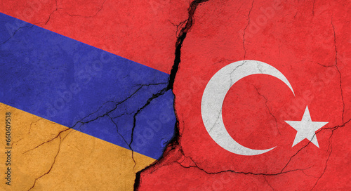 Flags of Armenia and Turkey, concrete wall texture with cracks, grunge background, concept of military conflict