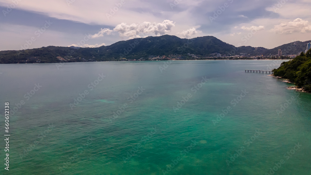 Beautiful beach with colorful water. Top view of the beautiful coastline. Sunny summer day. Colorful water. Sandy beach. Beautiful beach with colorful water. Top view of the beautiful coastline. Sunny summer day. Colorful water. Sandy beach.