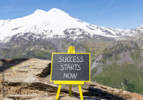 Success starts now symbol. Concept word Success starts now on beautiful black blackboard. Beautiful mountain Elbrus blue sky background. Business motivational success starts now concept. Copy space. © Dzmitry