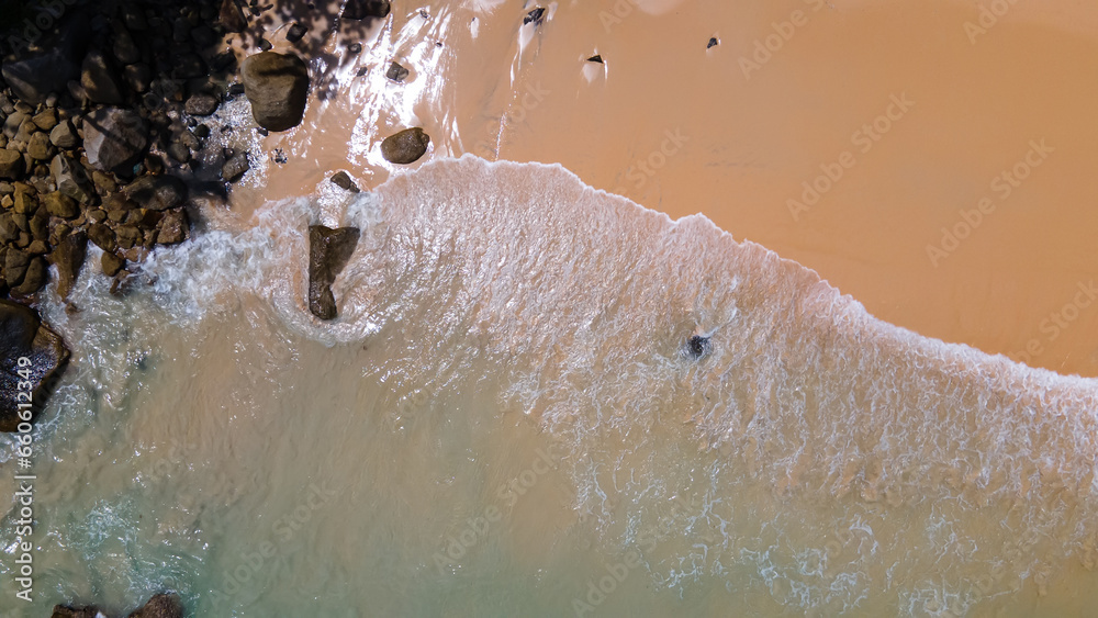 Fototapeta premium Beautiful beach with colorful water. Top view of the beautiful coastline. Sunny summer day. Colorful water. Sandy beach. 