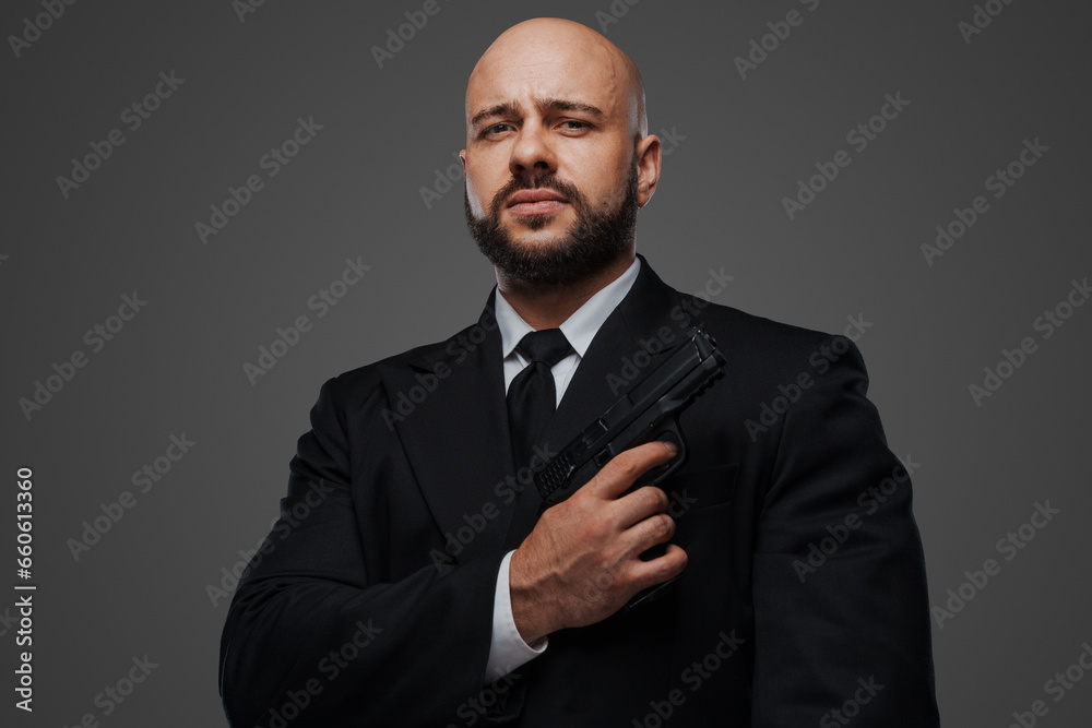 Commanding portrait of a bald, bearded gentleman with a gun, dressed sharply in formal attire Commanding portrait of a bald, bearded gentleman with a gun, dressed sharply in formal attire