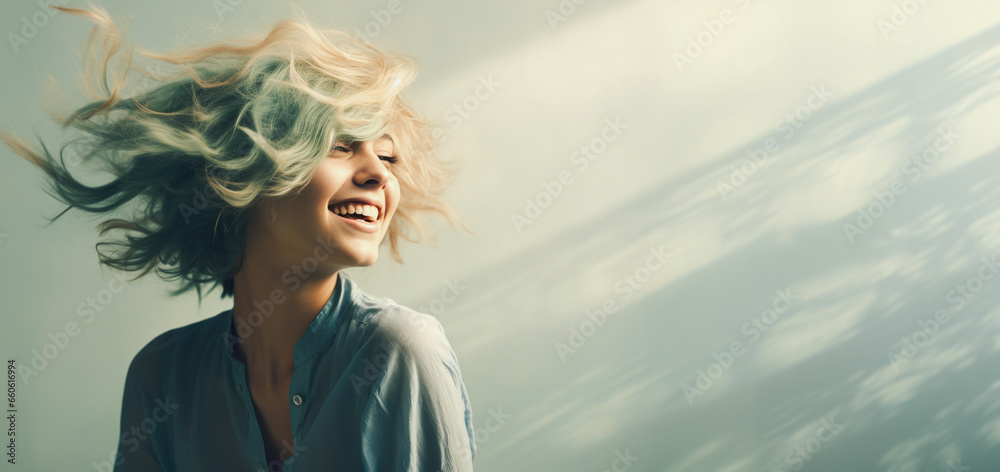 A young, smiling, and confident girl with ombre turquoise and orange hair, which the wind is blowing in various directions. - obrazy, fototapety, plakaty 