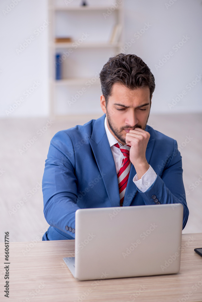 Young male employee working in the office