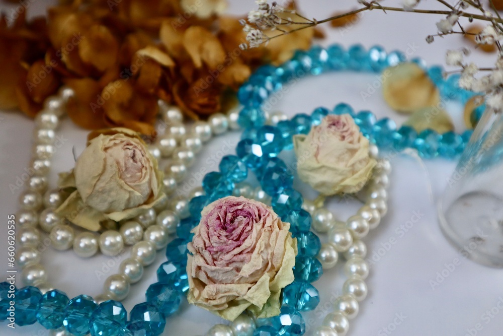 White and blue beads with dried rose buds
