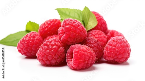 A pile of raspberries with leaves on a white surface