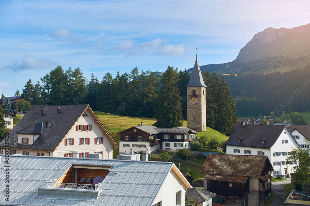 Churwalden village in Switzerland. Formerly Parpan. Beautiful swiss alpine countryside with a medieval bell tower and Rothorn mountain on background.