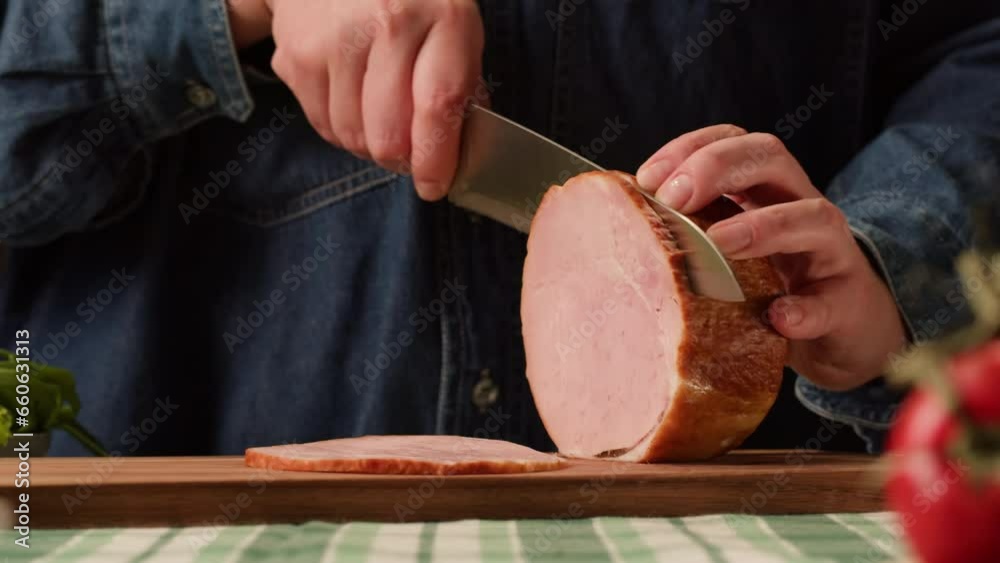 Woman slices ham bacon meat thick pieces on a wooden board, beef or pork jamon. Chef cooking breakfast, smoked bacon in cafe. 