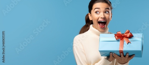Beautiful happy teenage woman smiling with gift box