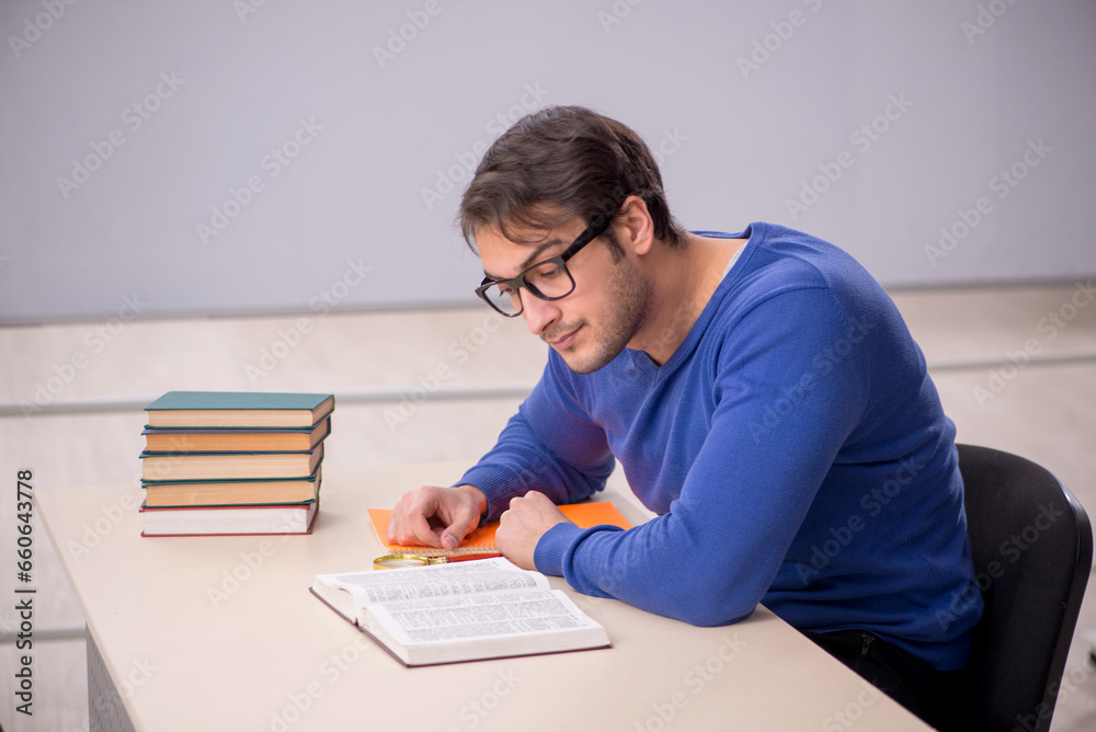 Young male student preparing for exams in the classroom Young male student preparing for exams in the classroom