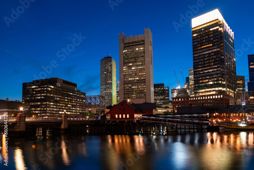 Panoramic city view of Boston Harbour and Seaport Blvd evening and night time  Massachusetts. An intellectual  technological and political center.