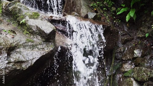 rainforest at the spectacular waterfall of El Pailon del Diablo close to Banos Santa Agua in the andes mountains of Ecuador, South America.