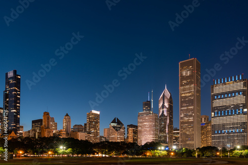 Chicago skyline panorama from Park at night time. Chicago, Illinois, USA. Skyscrapers of financial district, a vibrant business neighborhood.