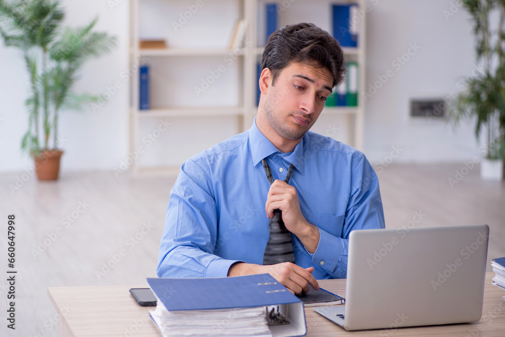 Young male employee working in the office Young male employee working in the office