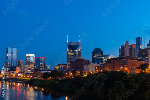 Scenic View of Broadway district of Nashville over Cumberland River at illuminated night skyline, Tennessee, USA. This city is known as a center for the music industry, especially country music