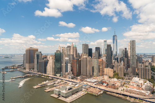 Aerial panoramic city view on Lower Manhattan district and financial Downtown, New York City, USA. Bird's eye view from helicopter. A vibrant business neighborhood. Hudson River and East River.