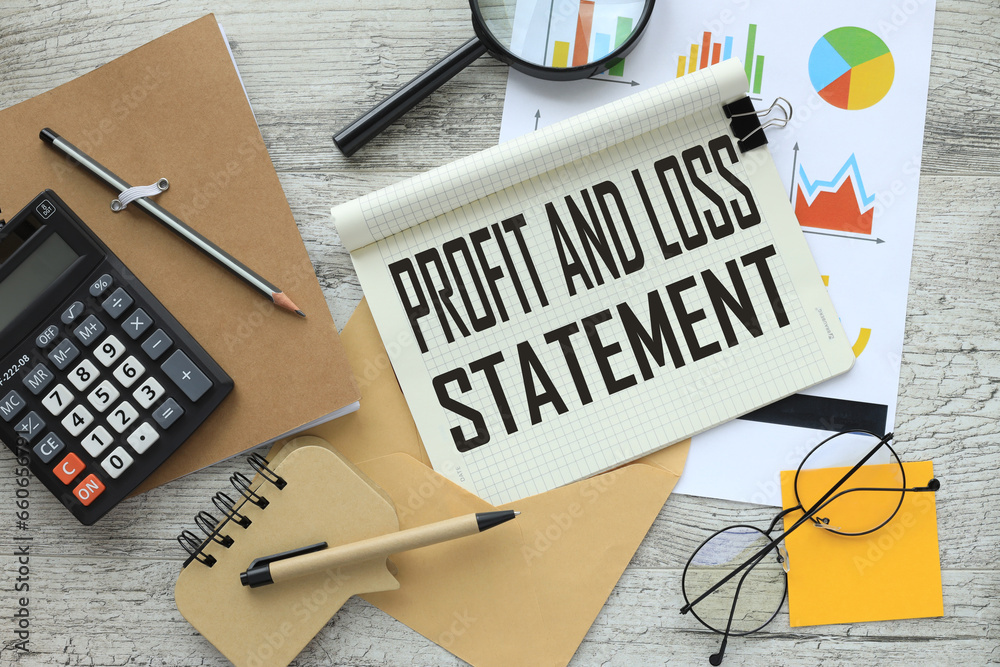 profit and loss statement stationery and calculator on financial chart ...