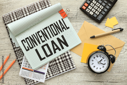 Conventional Loan open notepad on colorful notepad. calculator. a table clock