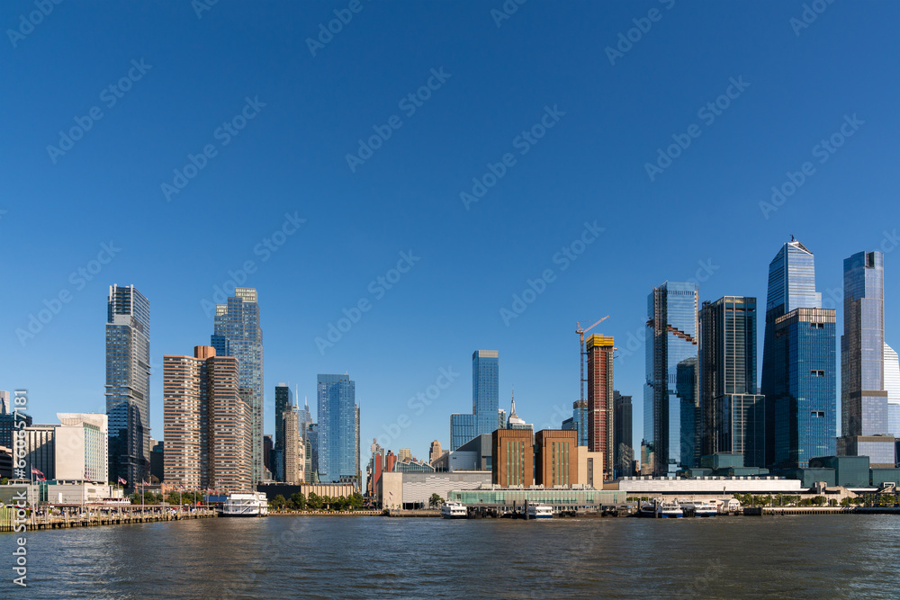 Obraz premium New York City skyline from New Jersey over the Hudson River with the skyscrapers of the Hudson Yards district at day time. Manhattan, Midtown, NYC, USA. A vibrant business neighborhood